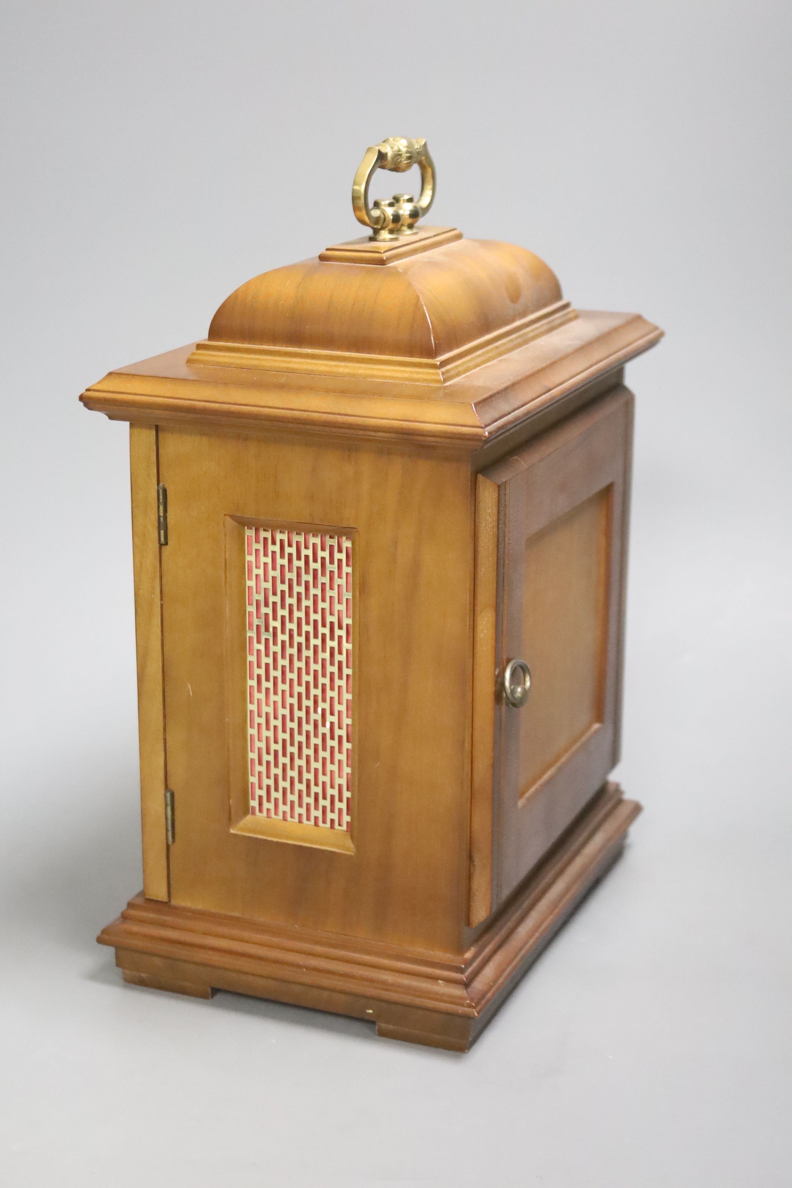 A modern walnut mantel clock, with German striking and chiming movement, height 29cm